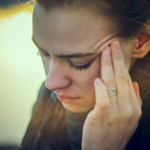 Woman holding her head in pain. 